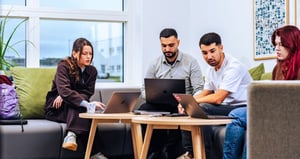 People working together and looking at screens