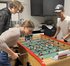 Employees Playing Foosball at the UNIwise Offices