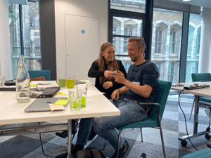 UNIwise employees at Jisc conversing and having a good time in a meeting room
