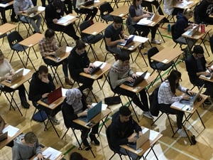 Students taking a digital assessment in an exam hall from a top-down perspective