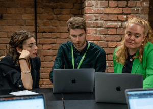 Attendees of WISEcon22 looking at software on laptops