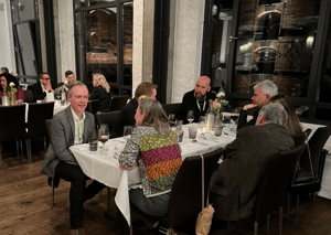 Attendees of WISEcon24 enjoying themselves over a glass of wine at the WISEcon24 dinner